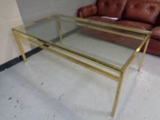 A late 20th century brass glass topped coffee table