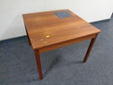 A mid 20th century Danish teak square coffee table with a tile inset panel