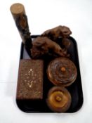 A tray containing wooden pieces to include a pair of carved eastern bookends, lidded trinket pots,