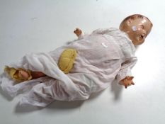 A mid 20th century plastic headed doll