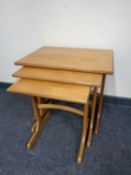 A nest of three teak tables