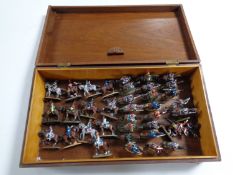 A wooden table box containing a quantity of metal military figures,