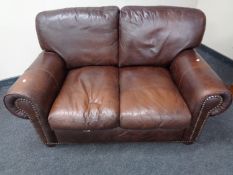 A brown leather two seater settee