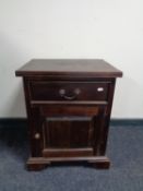 An eastern hardwood bedside cabinet fitted a drawer