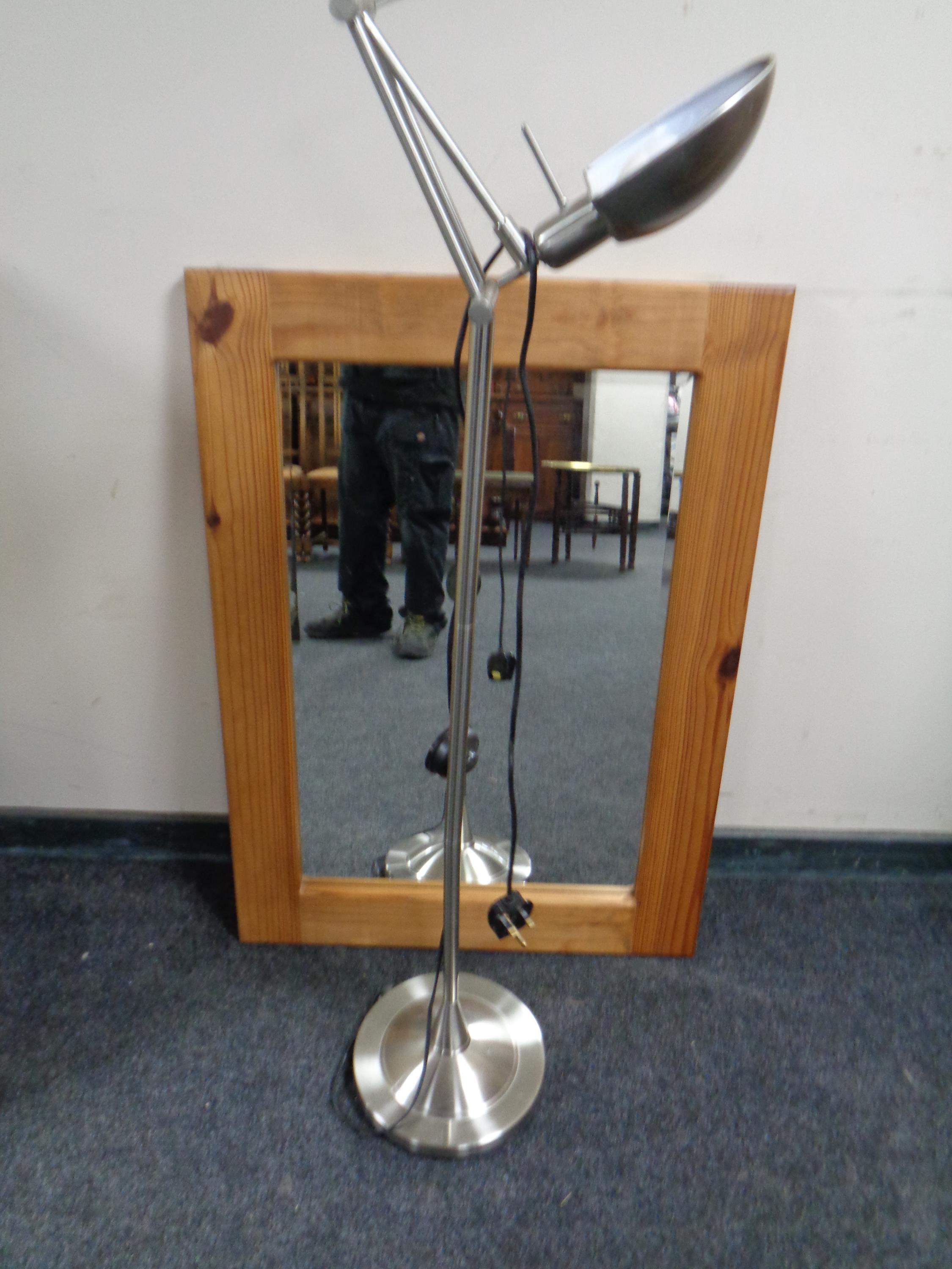 A contemporary pine bevelled mirror together with a standard lamp