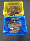 Two plastic baskets containing vintage woodworking planes, clamps,