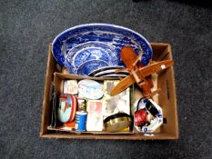 A box containing antique and later blue and white plates, vintage tins, wooden model of an airplane,