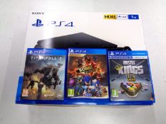 A boxed Sony PS4 1TB together with three games CONDITION REPORT: This has been out
