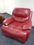 A red leather manual reclining armchair