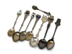 Eight silver spoons, some enamel examples.