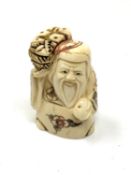 A carved hardwood Chinese netsuke - Village elder with bread basket