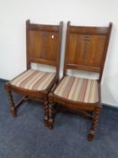 A pair of 20th century oak panel back dining chairs on barley twist legs
