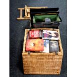 A wicker hamper containing assorted books together with a box containing artist's easel,