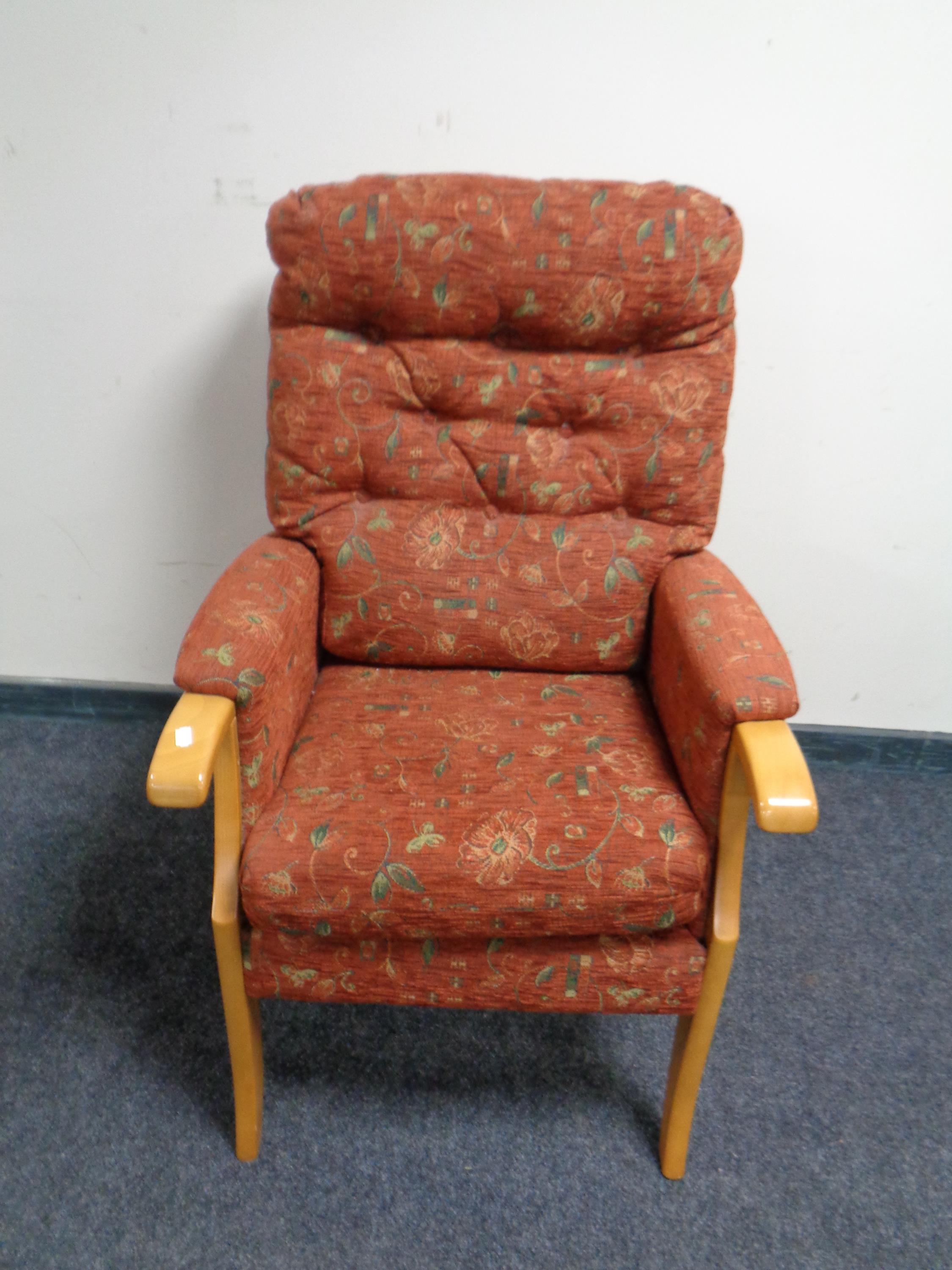 A contemporary armchair in buttoned upholstery