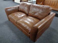 A brown stitched leather two seater settee
