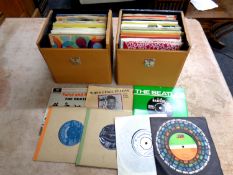 Two cases containing vinyl 7 inch singles to include The Beatles,