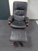 A black leather swivel relaxer armchair with stool