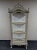 A French style painted display cabinet fitted shelves