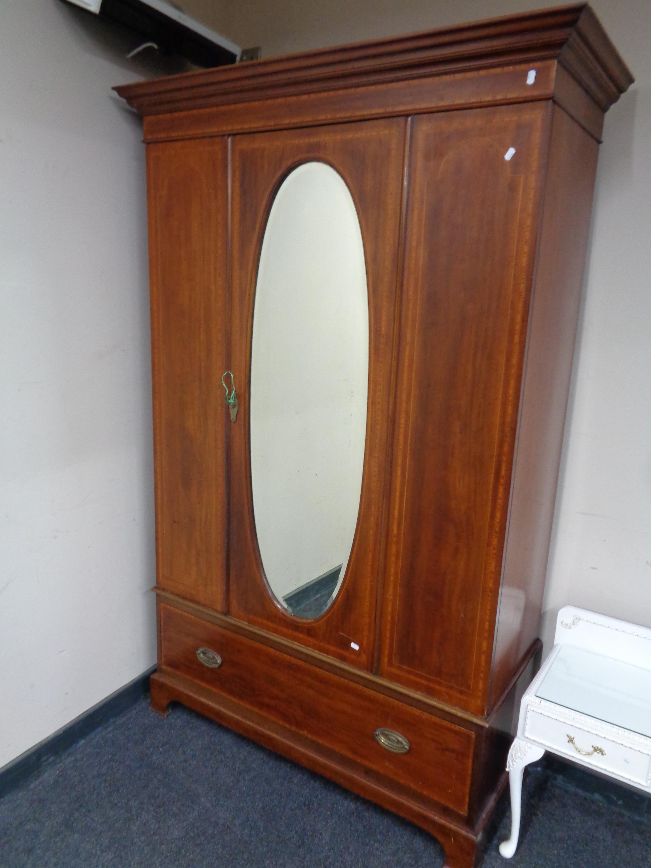 A late Victorian inlaid mahogany mirror door wardrobe fitted a drawer beneath
