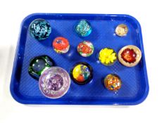 A tray containing 10 assorted glass paperweights