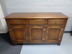 A Bevan Funnell oak triple door sideboard fitted three drawers above