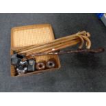 A vintage leather case containing walking sticks, folding easel,