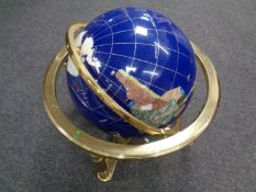 A large gemstone globe on brass stand