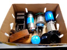 A box containing camping gas stoves and canisters, vintage bench vice,