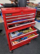 A Clarke metal tool chest on cabinet containing a large quantity of assorted hand tools, hardware,