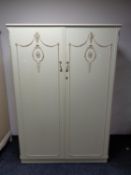 A French style cream and gilt two door wardrobe