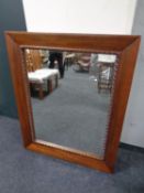 A large contemporary hardwood overmantel mirror