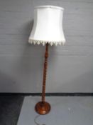 A beech wood barley twist standard lamp with shade