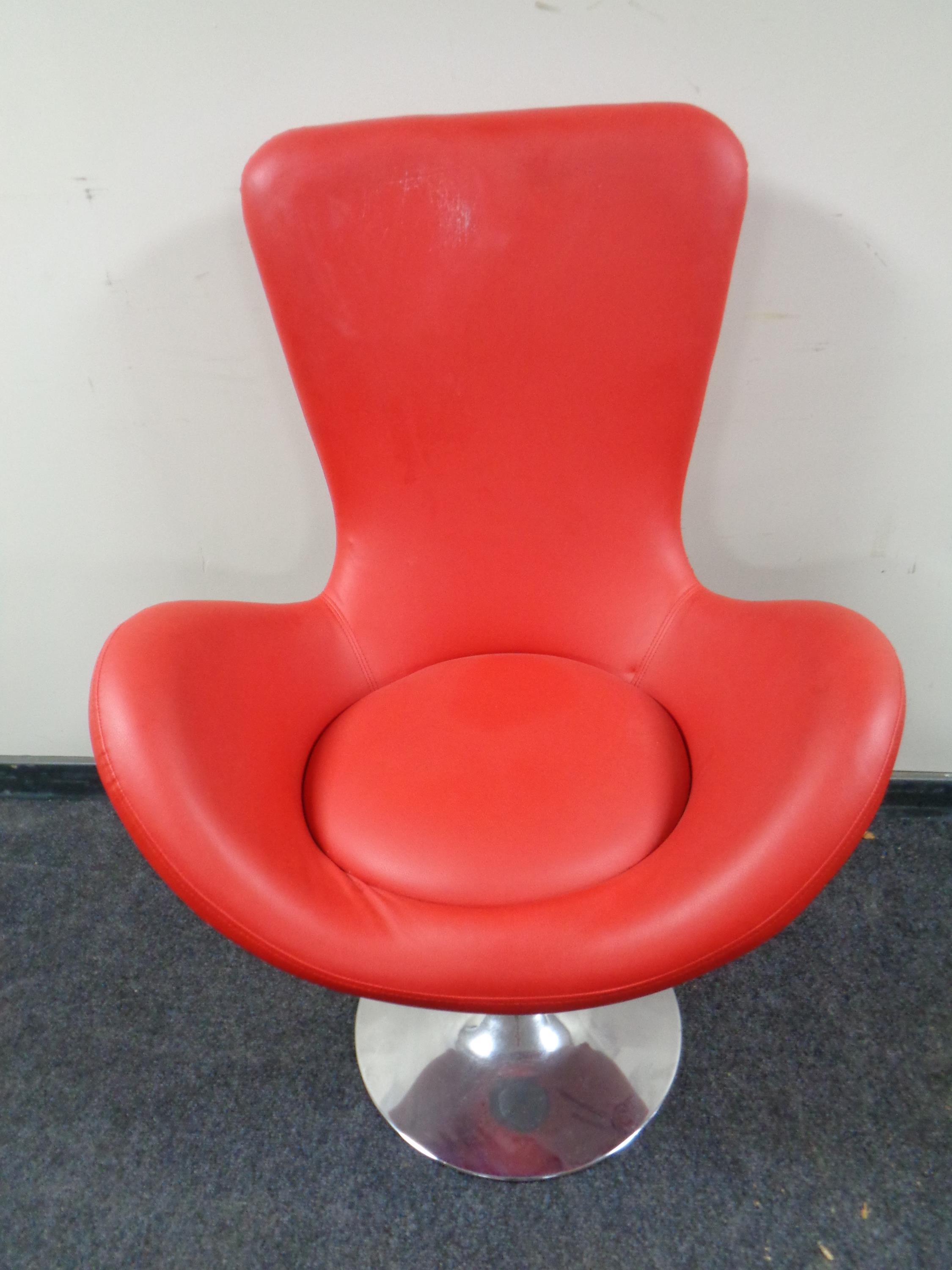 A retro swivel chair on chrome circular pedestal base