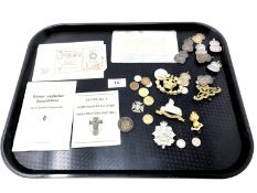 A tray containing bank notes, nine silver ARP badges, militaria including cap badges etc, coins.