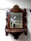 A Victorian fretwork framed mirror with demi lune shelf