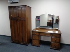 A four piece oak bedroom suite comprising lady's and gent's wardrobes,