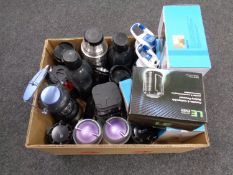 A box containing thermal drinking flasks, camping lights,