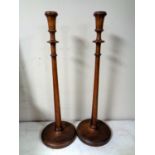 A pair of Edwardian mahogany candlesticks, height 53.
