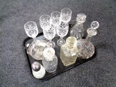A tray containing assorted glassware to include four assorted decanters with stoppers and decanter