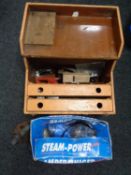 A boxed steam cleaner together with a wooden tool chest containing a small quantity of hand tools