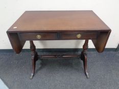 A regency style inlaid mahogany flap sided sofa table fitted two drawers