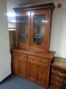 A 19th century stained oak double door bookcase fitted two drawers with sideboard beneath