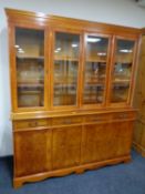 An inlaid yew wood four door bookcase