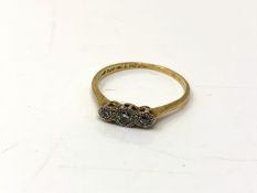 An 18ct gold and platinum three stone diamond ring, size S. CONDITION REPORT: 2.