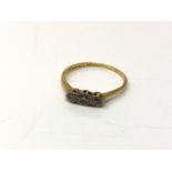 An 18ct gold and platinum three stone diamond ring, size S. CONDITION REPORT: 2.