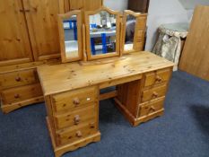 A pine Erinwood dressing table with triple mirror