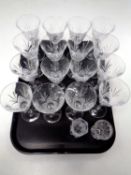 A tray containing a set of 16 wine glasses together with two cut glass vases
