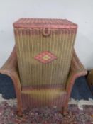 A pink Lloyd loom basket chair together with a linen box