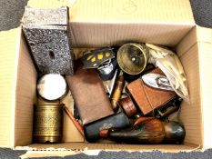 A box of collectables including an antique corkscrew, AA badge, table lighter in the form of a boat,