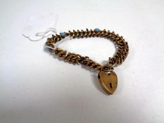 A late Victorian gold plated padlock bracelet with cabochon turquoise decoration